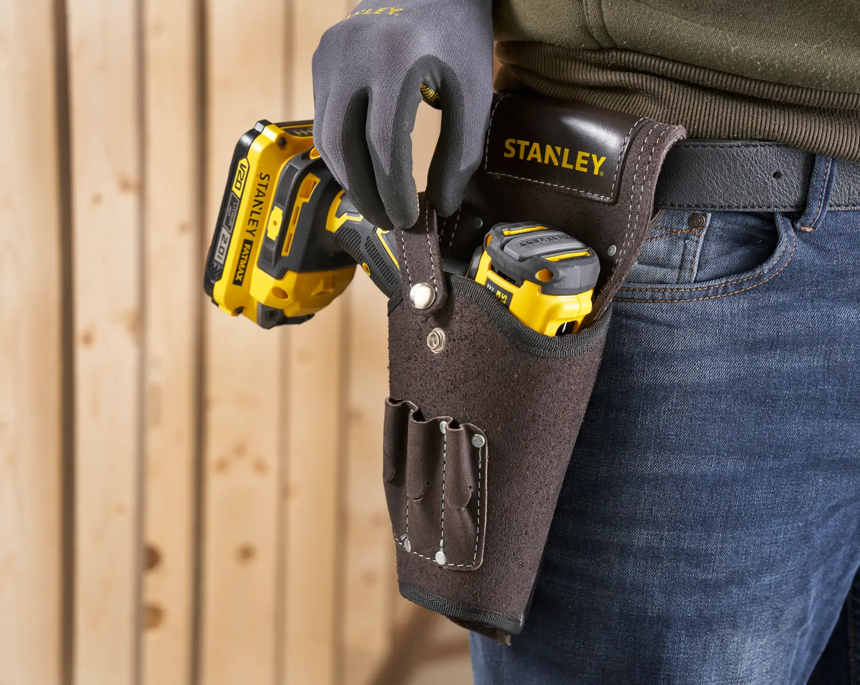 STANLEY STST1-80118 funda de herramientas de cuero en cinturón, con herramientas eléctricas amarillas, vista de cerca.